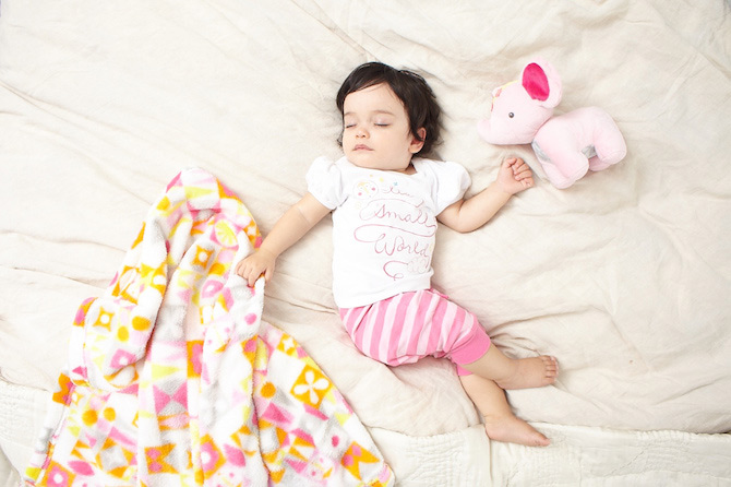 Sleeping baby on white blanket