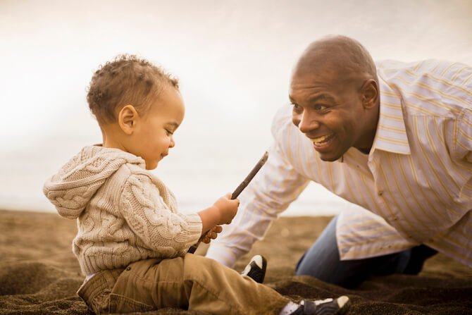 Song and dad playing outside together