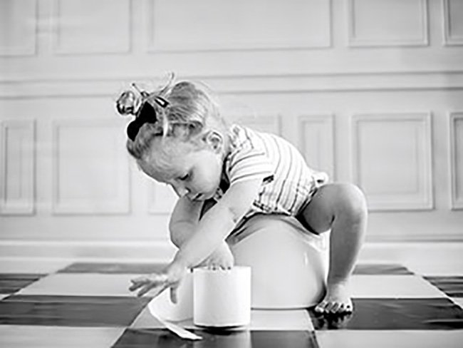 little girl with toilet paper