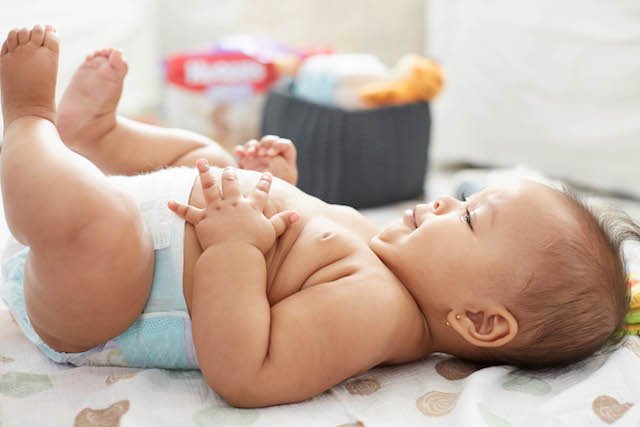 baby lying on back in diaper