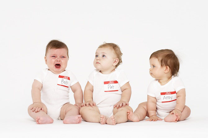 three babies with nametags