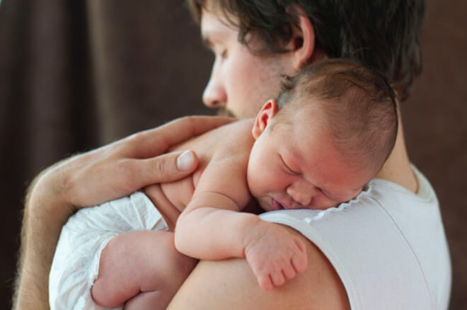 Father Hugging Infant in Huggies Special Delivery Diapers